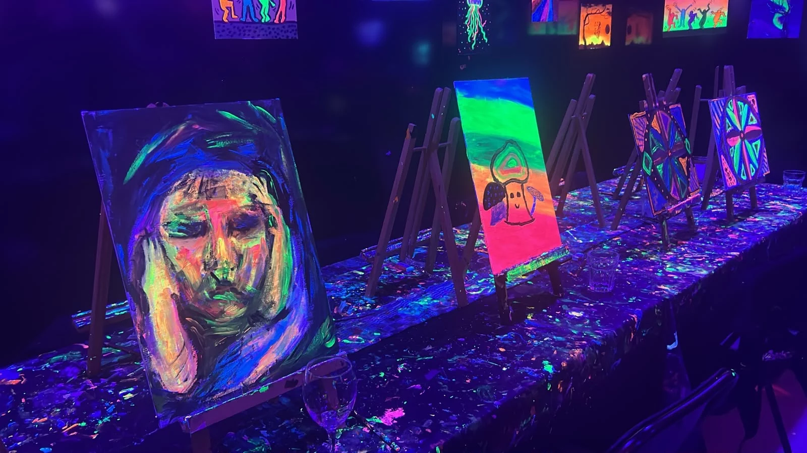 Different fluorescent paintings on easels during Rembrandt van Wine in Amsterdam